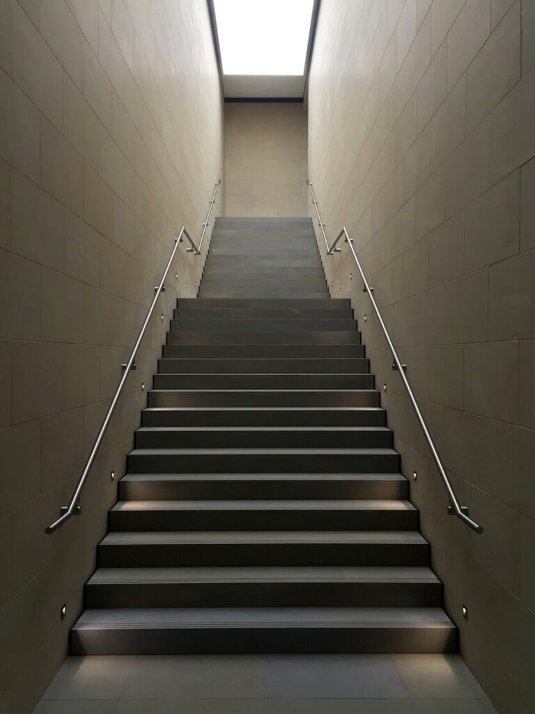gray concrete stair with gray steel handle